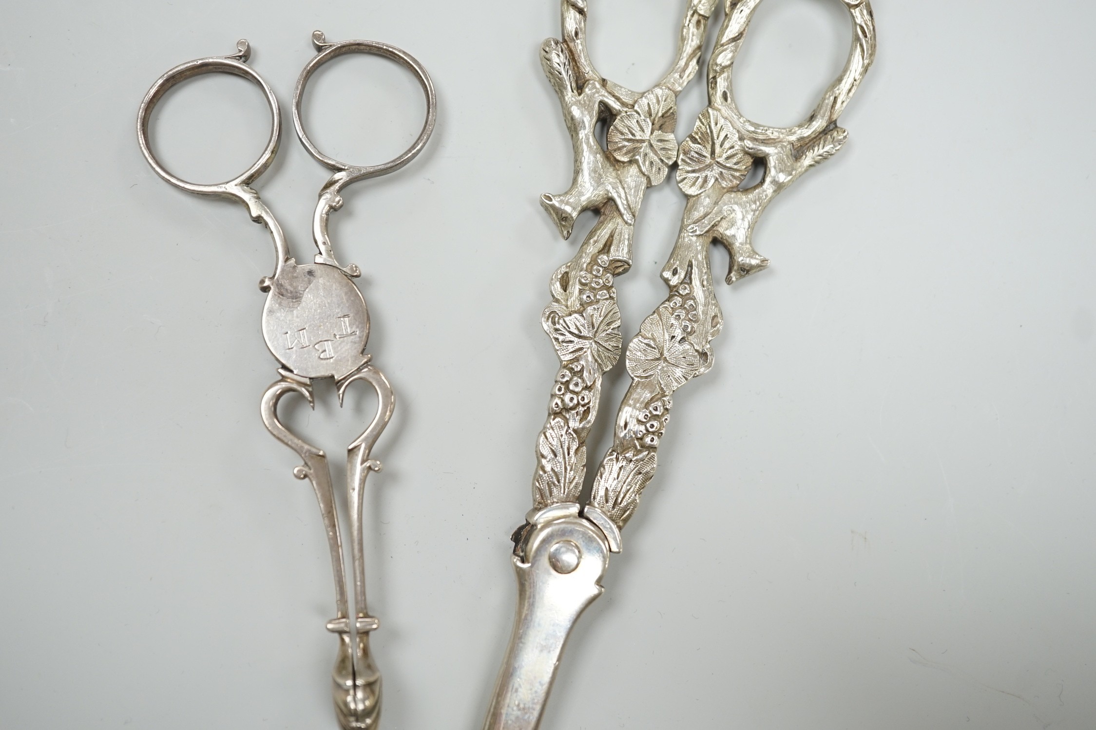 A pair of Victorian silver grape scissors, TS?, London, 1879, 17cm and a pair of Georgian silver sugar nips by Simeone Coley?